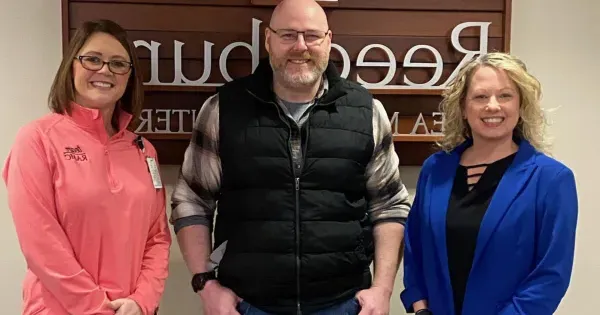 Jake Griebe poses for a photo with Madison College-Reedsburg staff.